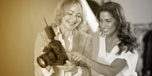 Two marketing professionals reviewing photos on a camera