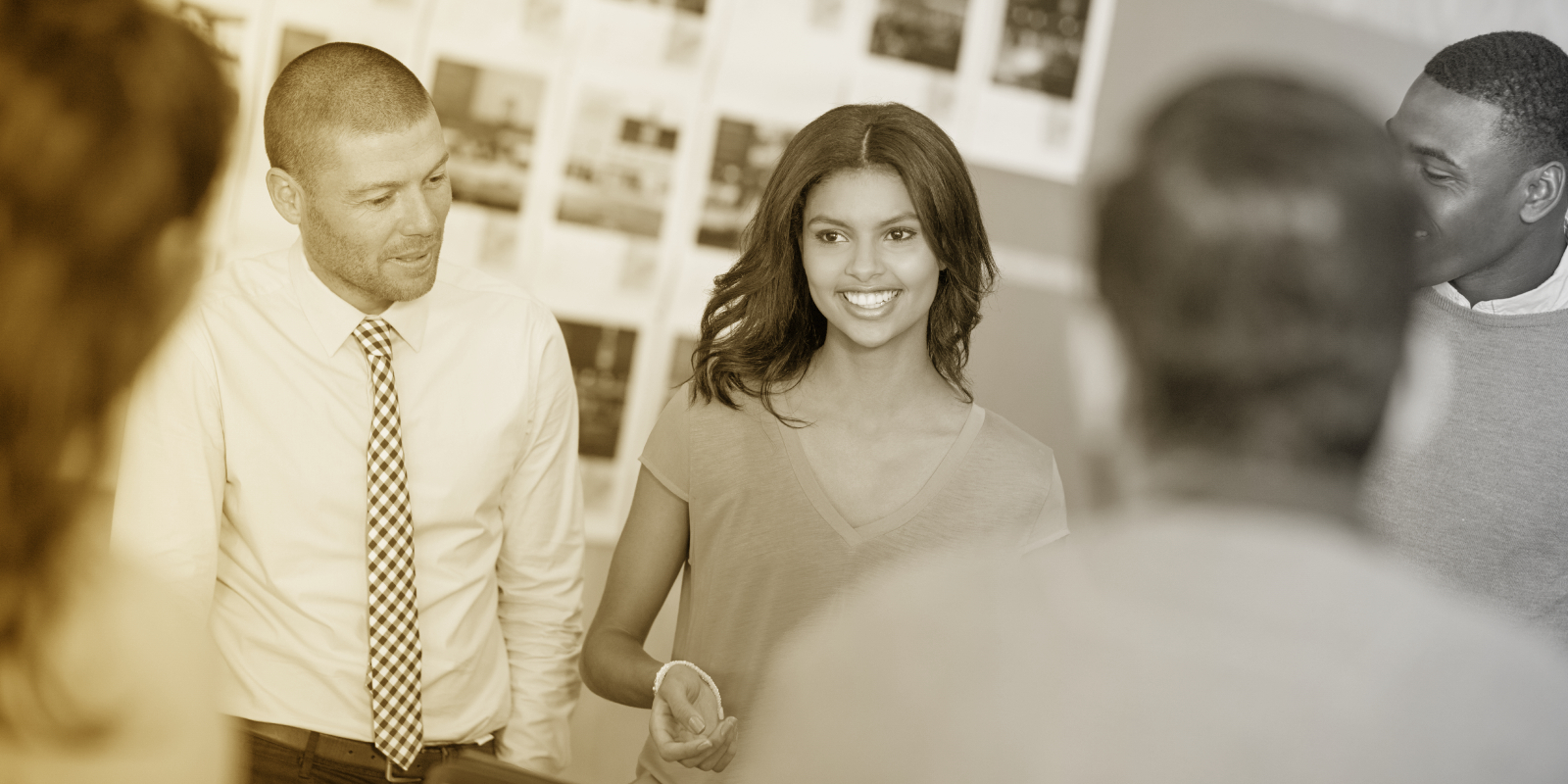 Five young professionals gathered for a sales meeting