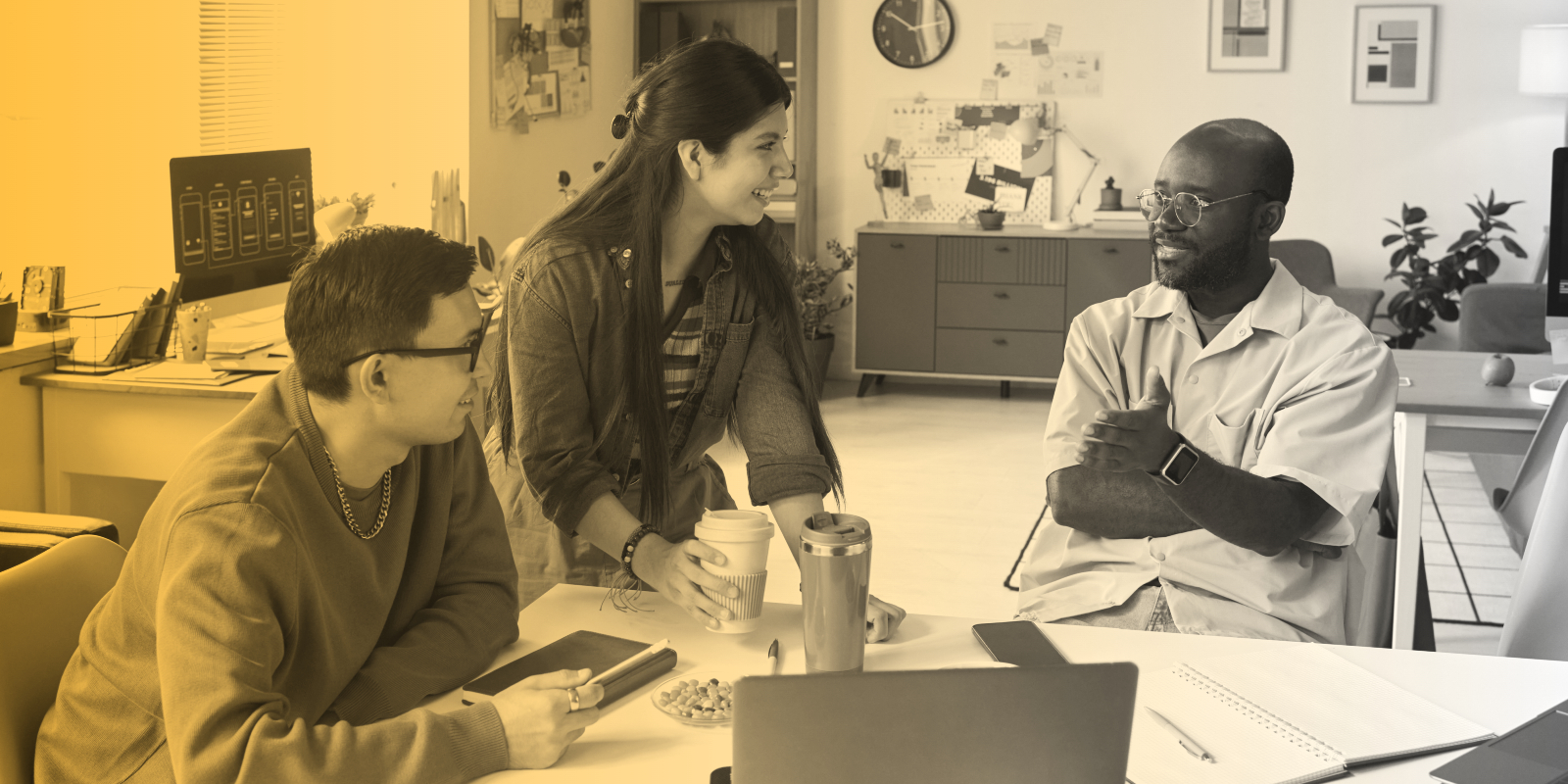 Creative professionals collaborating around an office desk