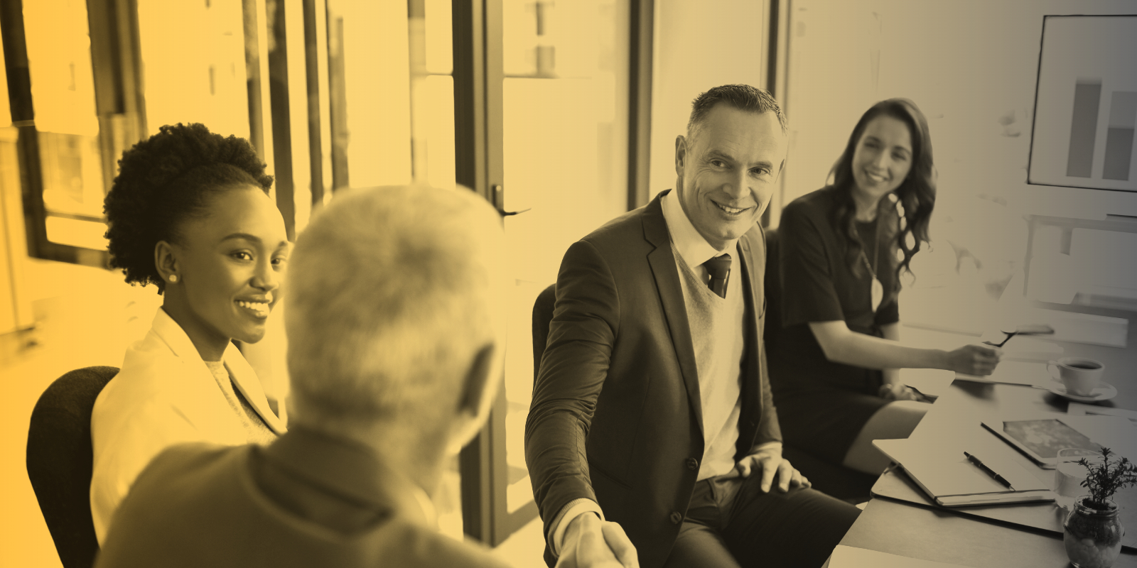 Smiling professionals meet around a table
