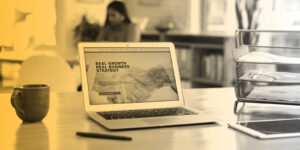 Laptop sitting on a desktop, displaying a website