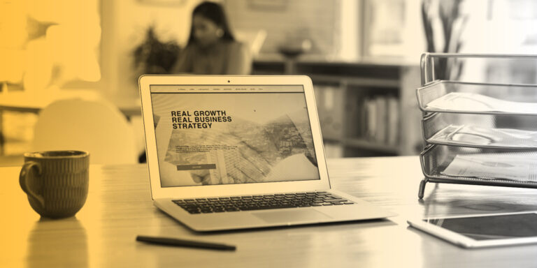 Laptop sitting on a desktop, displaying a website