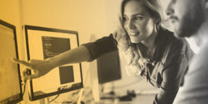 Two professionals collaborating at a computer workstation