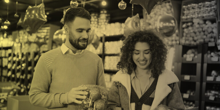 Happy couple shops for ornaments for Christmas